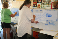 Students trying out some of the basic airbrush strokes. Click here to view larger image.